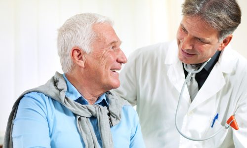 close up of a male doctor discussing with senior man